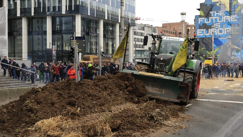 Tractor dumping manure near European council building in Brussels