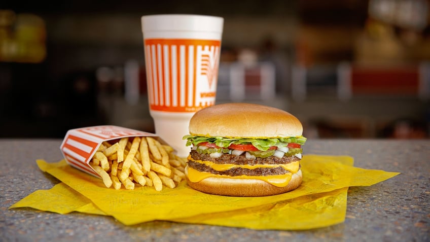 A double cheeseburger combination meal with fries and a drink are shown at Whataburger.