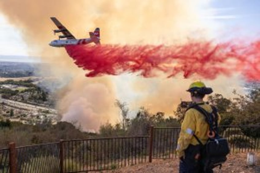 Fast-moving California wildfire destroys dozens of homes, forces thousands to flee