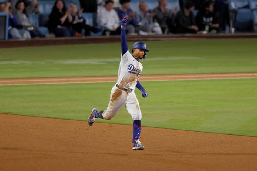 Los Angeles, CA Dodgers' Mookie Betts points skyward while rounding the bases after hitting a homer past the Giants on a line drive to left center...