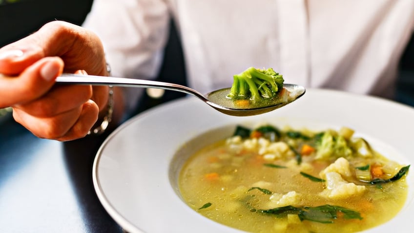 Woman eating soup