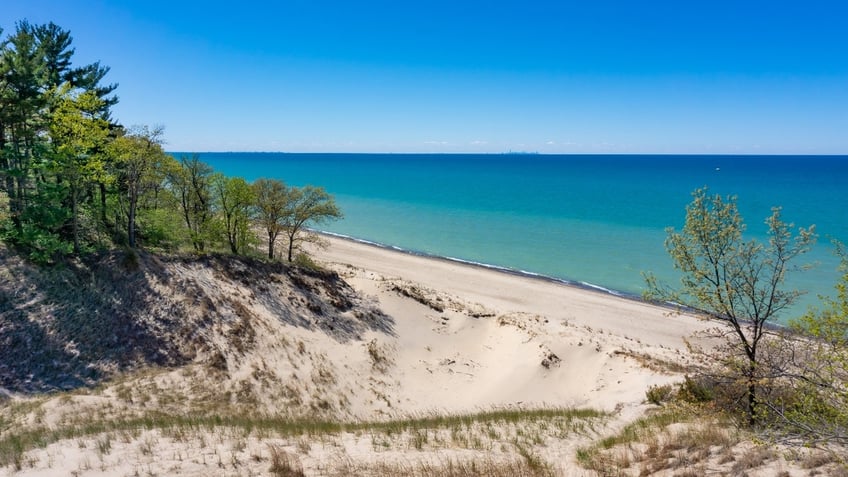 A view of Lake Michigan surrounded by sand dunes