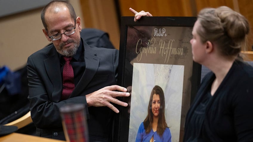 Timothy Hoffman places a photo of his daughter