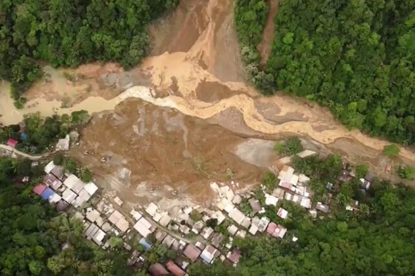 The landslide buried a bus terminal for employees of a gold mining firm and 55 nearby hous