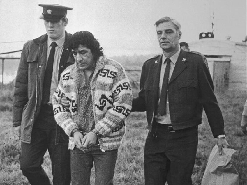 (Original Caption) Leonard Peltier, American Indian Movement leader, is led across Okalla