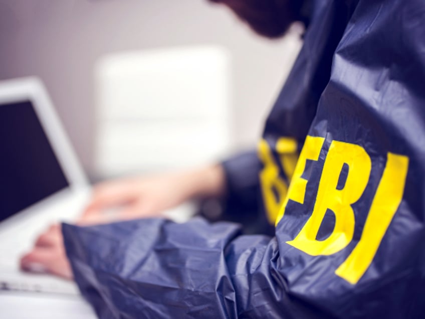 FBI agent working on his computer in office