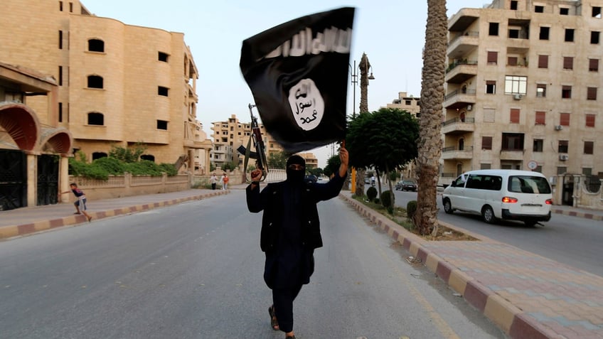 ISIS member raises flag