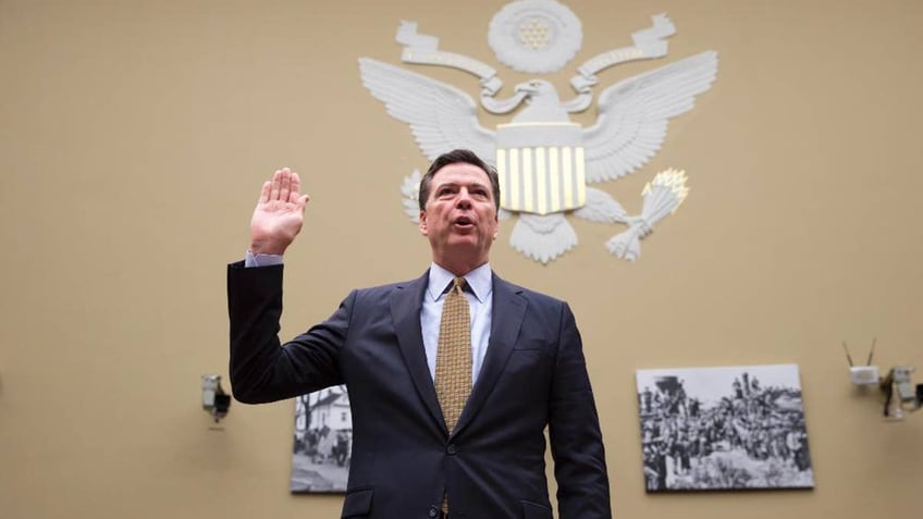 FBI Director James Comey is sworn in on Capitol Hill in Washington, Thursday, July 7, 2016, prior to testifying before the House House Oversight and Government Reform Committee hearing to explain his agency's recommendation to not prosecute Democratic presidential candidate Hillary Clinton over her private email setup. (AP Photo/J. Scott Applewhite)