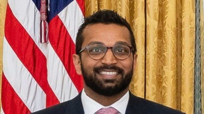 Kash Patel headshot with US flag behind him