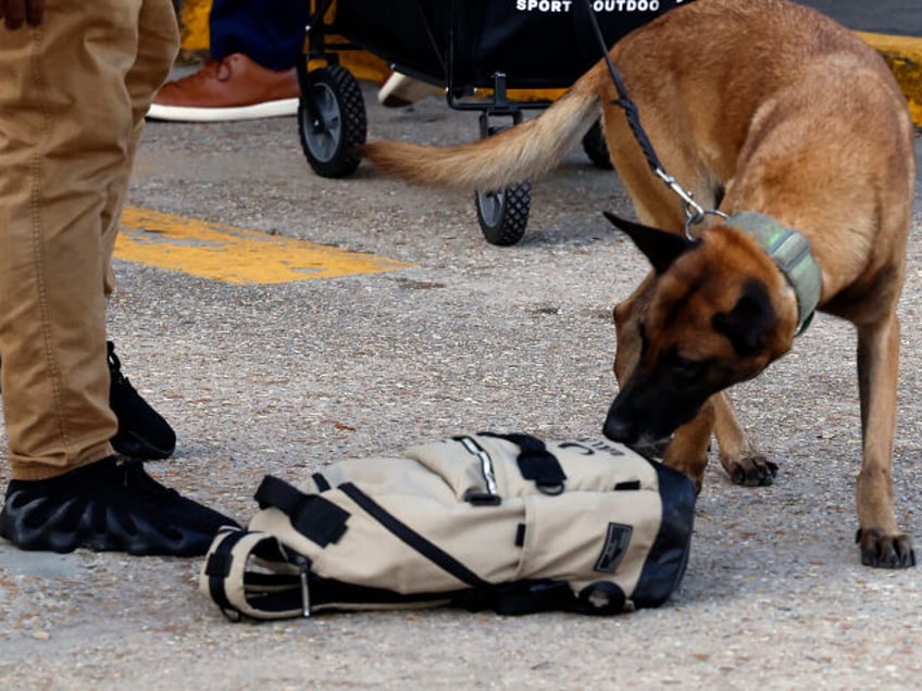 Security and bomb sniffing dogs check backpacks before entering the Superdome ahead of the