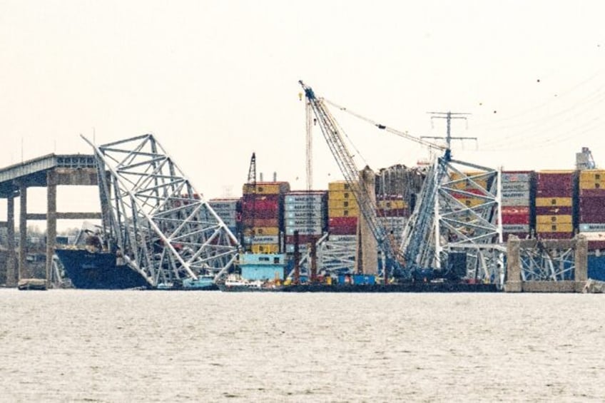 The container ship Dali is seen pinned under fallen wreckage of the Francis Scott Key Brid