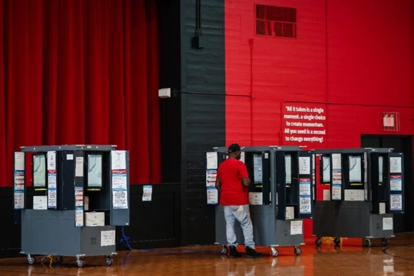 A voter casts his ballot in a polling place on Election Day in College Park, Georgia, Nove