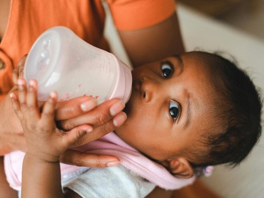 Baby drinking formula from bottle