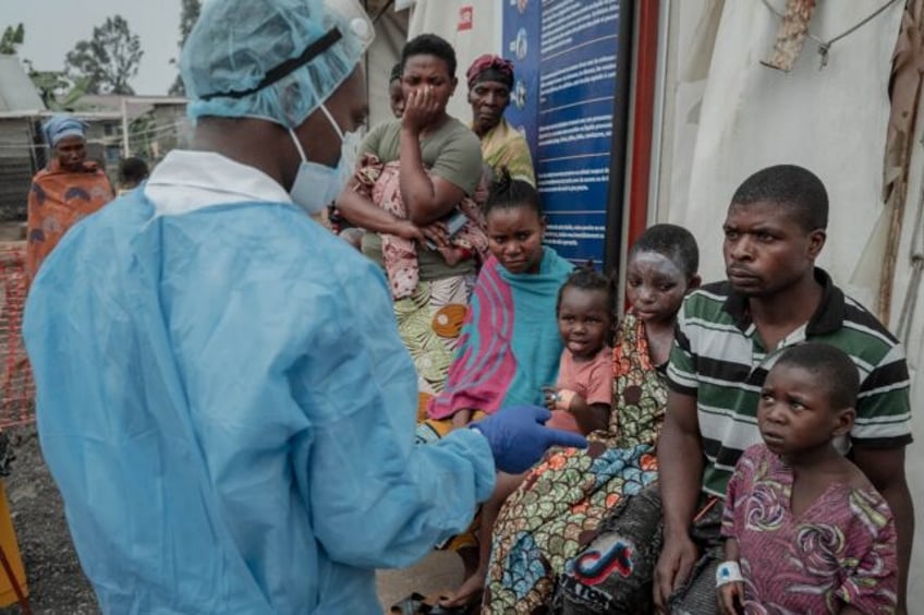 Patients listen to a doctor at an mpox treatment centre at Nyiragongo General Referral Hos