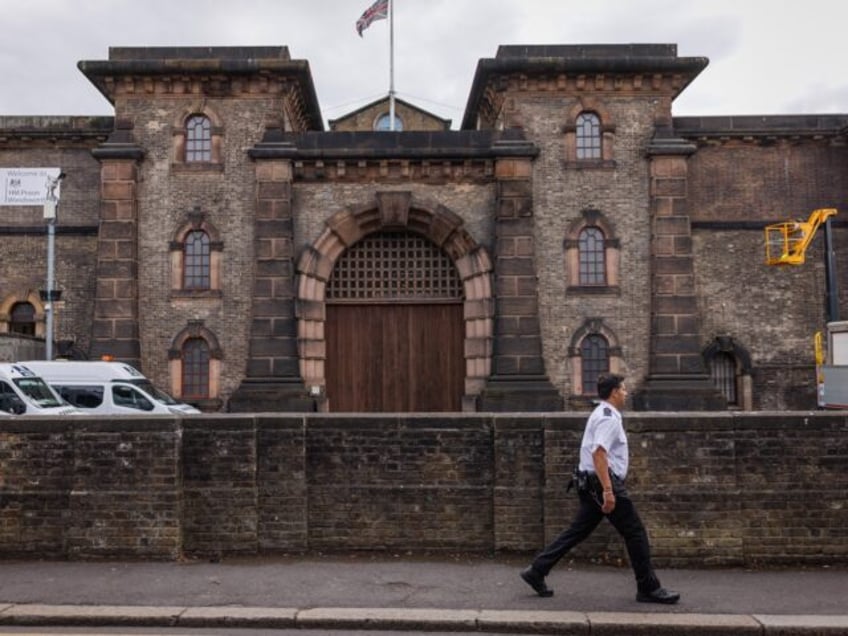 LONDON, ENGLAND - JULY 12: A prison guard walks past HMP Wandsworth prison on July 12, 202