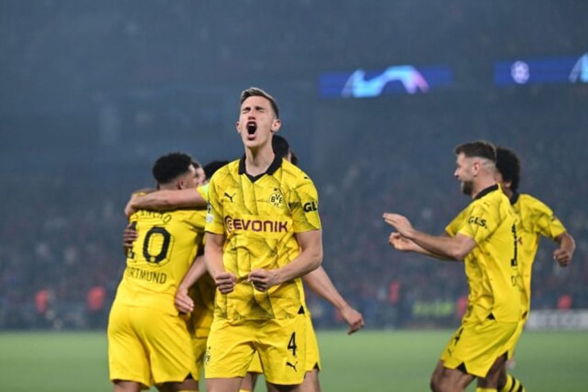 Schlotterbeck (2L) celebrates with Dortmund after beating Paris Saint-Germain in the Champ