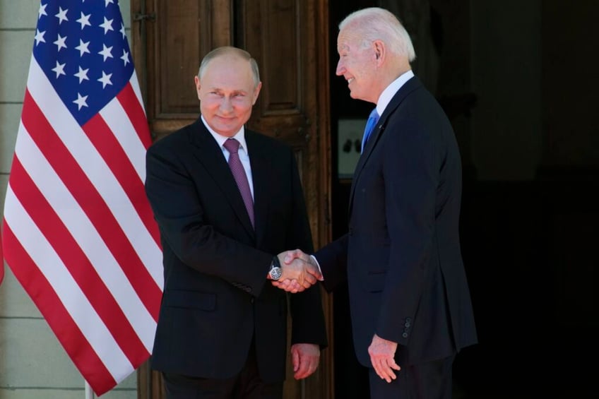 FILE - Russian President Vladimir Putin, left, and U.S President Joe Biden shake hands during their meeting at the 'Villa la Grange' in Geneva, Switzerland in Geneva, Switzerland, on June 16, 2021. Vladimir Putin on Friday Dec. 8, 2023 moved to prolong his repressive and unyielding grip on Russia for another six years, announcing his candidacy in the 2024 presidential election that he is all but certain to win. (AP Photo/Alexander Zemlianichenko, Pool, File)