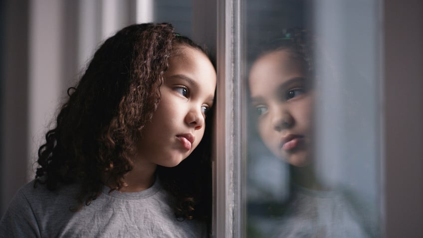 Sad girl at window