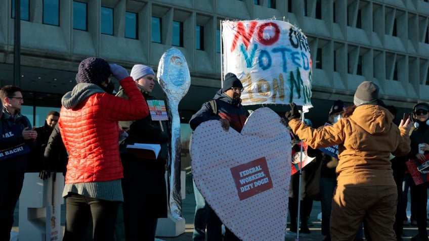 WASHINGTON, DC - FEBRUARY 14: Protesters demonstrate in support of federal workers outside of the U.S. Department of Health and Human Services on February 14, 2025 in Washington, DC. Organizers held the protest to speak on the Department of Government Efficiency (DOGE) cuts.