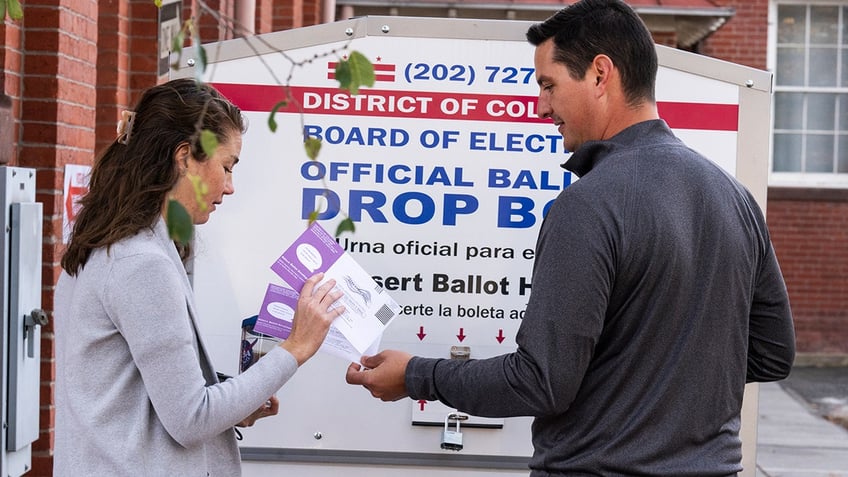Voters on election day turn in their ballots