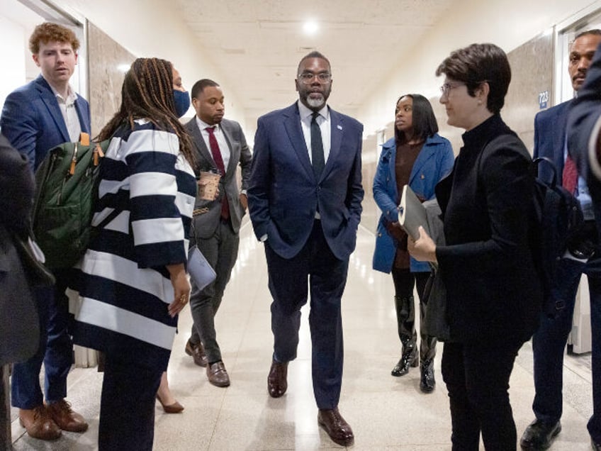 Mayor Brandon Johnson departs with staff members after a meeting with Gov. JB Pritzker at