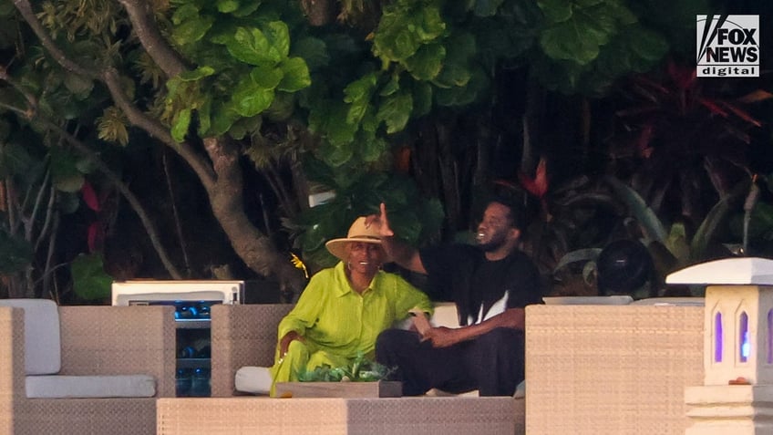 Sean "Diddy" Combs sits outside of his Star Island home with his mother, Janice Combs, in Miami Beach, Florida