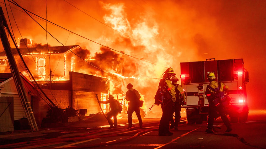 Firefighters in California battle the blaze that began Tuesday morning and has continued into Wednesday with little sign it will be under control soon as thousands evacuate.