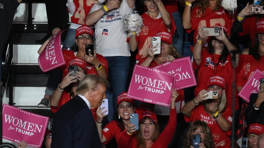 Women cheer as former President and Republican presidential candidate Donald Trump arrives to speak at a campaign rally in Reading, Pennsylvania