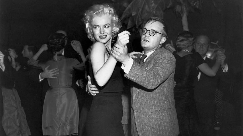 Truman Capote dancing with Marilyn Monroe