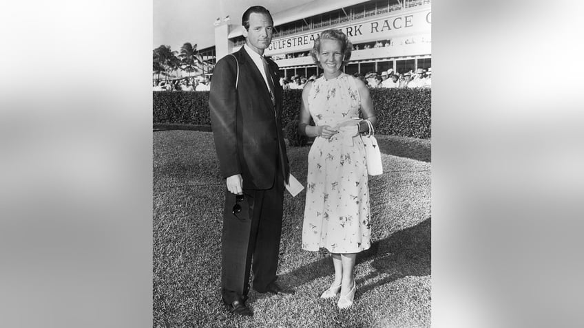 Ann Woodward wearing a floral dress next to her husband