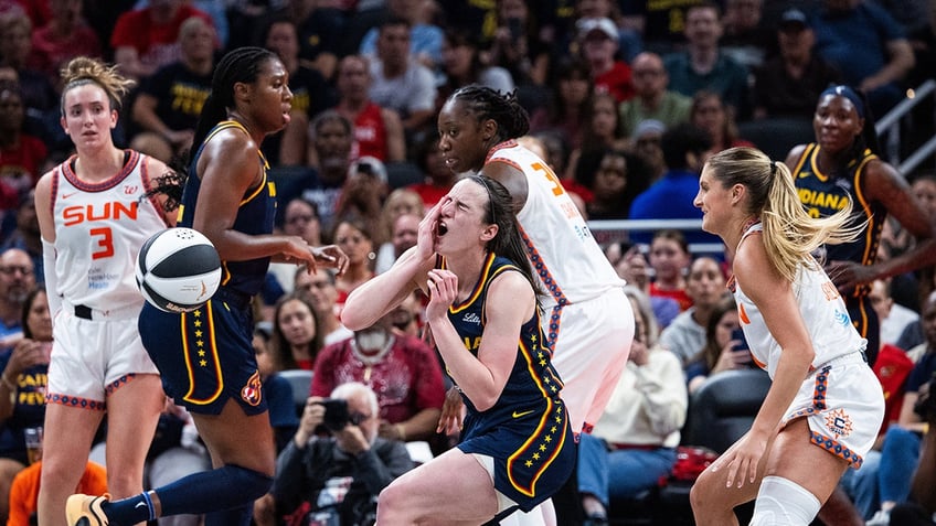 Caitlin Clark is fouled during a WNBA game