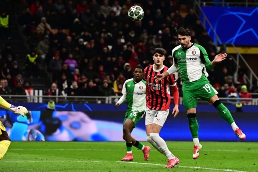 Feyenoord's Julian Carranza leaps to head the goal that knocked AC Milan out of the Champi