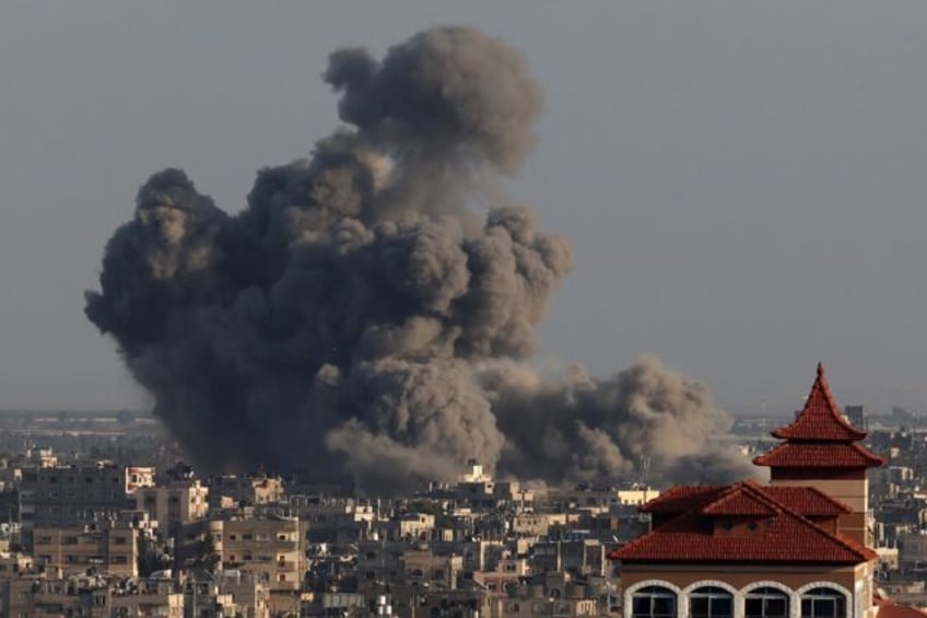 Smoke billows over Khan Yunis in the southern Gaza Strip during Israeli bombardments on January 24, 2024