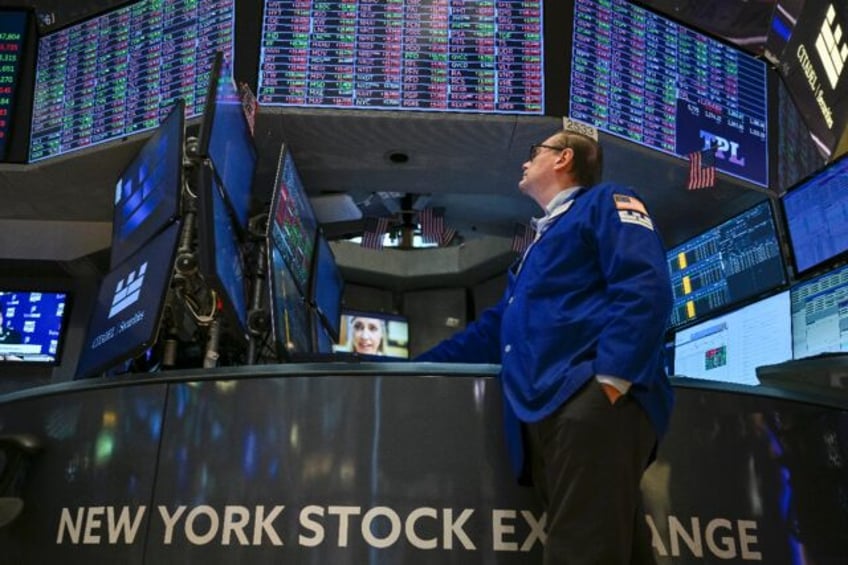 A trader works on the floor of the New York Stock Exchange (NYSE) at the opening bell earl