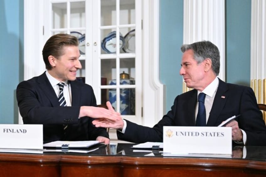 US Secretary of State Antony Blinken shakes hands with Finnish Defense Minister Antti Hakkanen during a ceremony for a defense cooperation agreement in the State Department's Treaty Room