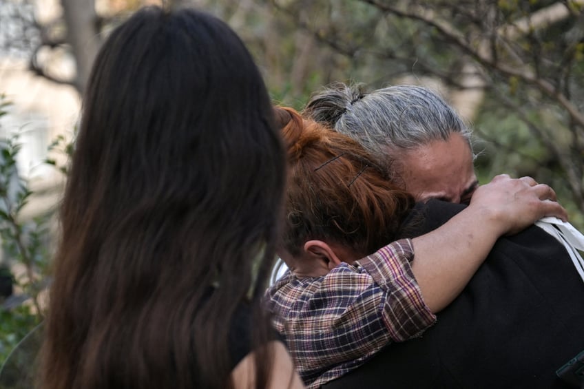 TOPSHOT - Relatives of victims react near the site of a fire in a residential building in Istanbul on April 2, 2024. A fire killed at least 29 people in a 16-storey residential building in Istanbul on April 2, the governor of Turkey's economic capital said, updating an earlier toll of 15 dead and eight hurt. The blaze had broken out during construction work in the first and second floors below ground, which housed a nightclub, governor Davut Gul told reporters. (Photo by OZAN KOSE / AFP) (Photo by OZAN KOSE/AFP via Getty Images)