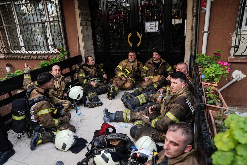 ISTANBUL, TURKIYE- APRIL 02: Some personnel from fire brigade rest amid extinguishing efforts and search-rescue efforts after a fire broke out in a nightclub in the basement of a 16-storey building in the Besiktas district of Istanbul, Turkiye on April 02, 2024. Death toll rises to 29 in the fire, says provincial governorship. Fire brigades and emergency teams were dispatched to the scene of the fire. The cause of the fire remains under investigation. (Photo by Hakan Akgun/Anadolu via Getty Images)