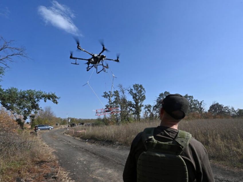 An operator of the volunteer organization 'Postup' controls the flight of an UAV carrying