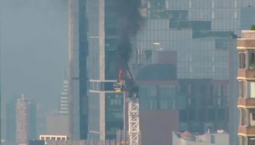 fire on new york construction crane causes arm to collapse and hit a building as it falls