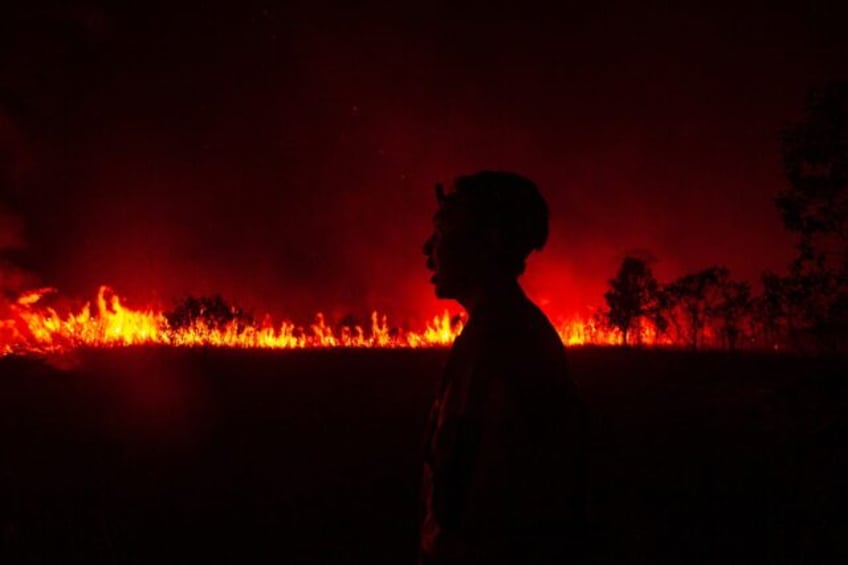 firefighters battle peatland blazes as haze shrouds indonesian city