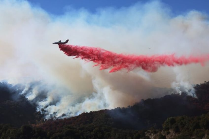 An aggressive air operation is under way to stem the spread of the Palisades Fire as it pu