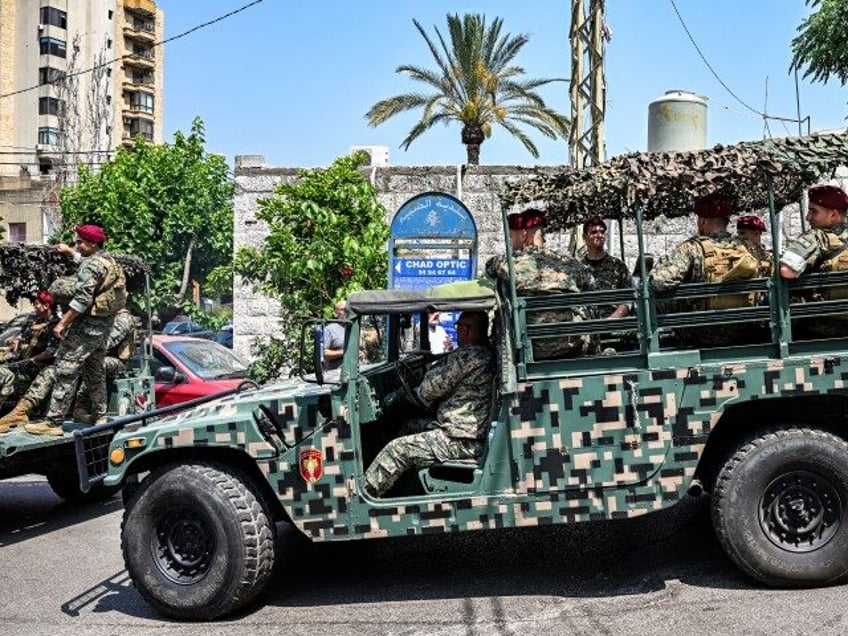 Lebanese army vehicles move along a road as soldiers deploy near the U.S. embassy in Beiru