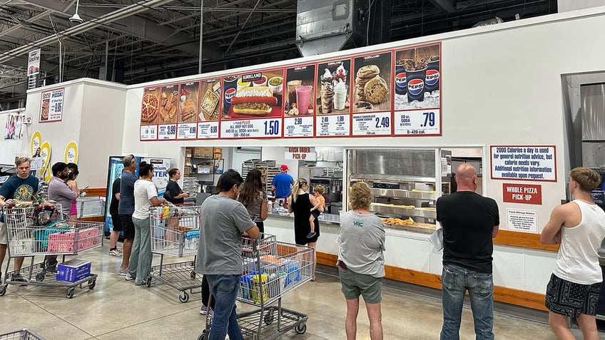 Costco members wait for their orders at a Costco food court