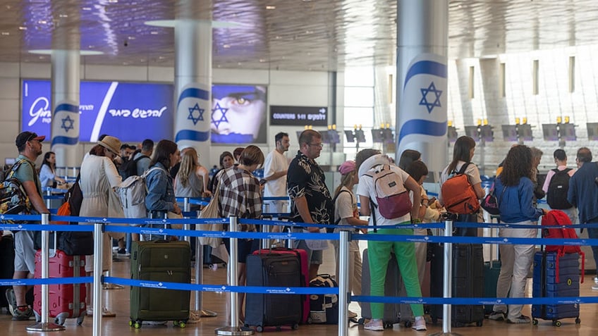 Passengers in line for check-in at Ben Gurion International airport in Tel Aviv, Israel, on Wednesday, June 25, 2025. Israel said its war against Iran was to prevent the country from acquiring atomic weapons, a risk also cited by Trump to justify US involvement. Photographer: Kobi Wolf/Bloomberg via Getty Images