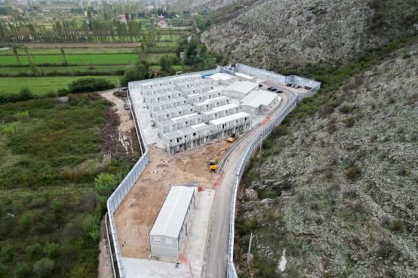 The processing centres are surrounded by high walls and security cameras