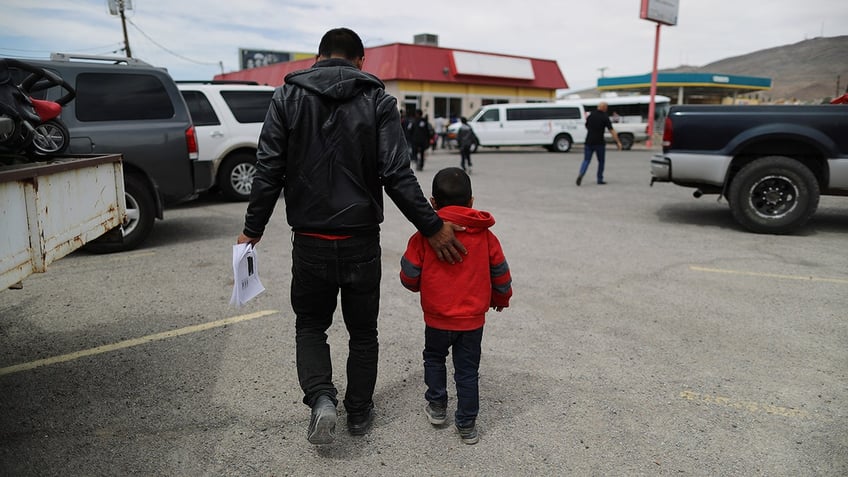 FILE - A migrant carries his ICE paperwork after being dropped off at a church serving as a shelter for migrants who are seeking asylum, after they were released by the U.S. Immigration and Customs Enforcement (ICE), on May 19, 2019 in El Paso, Texas. 