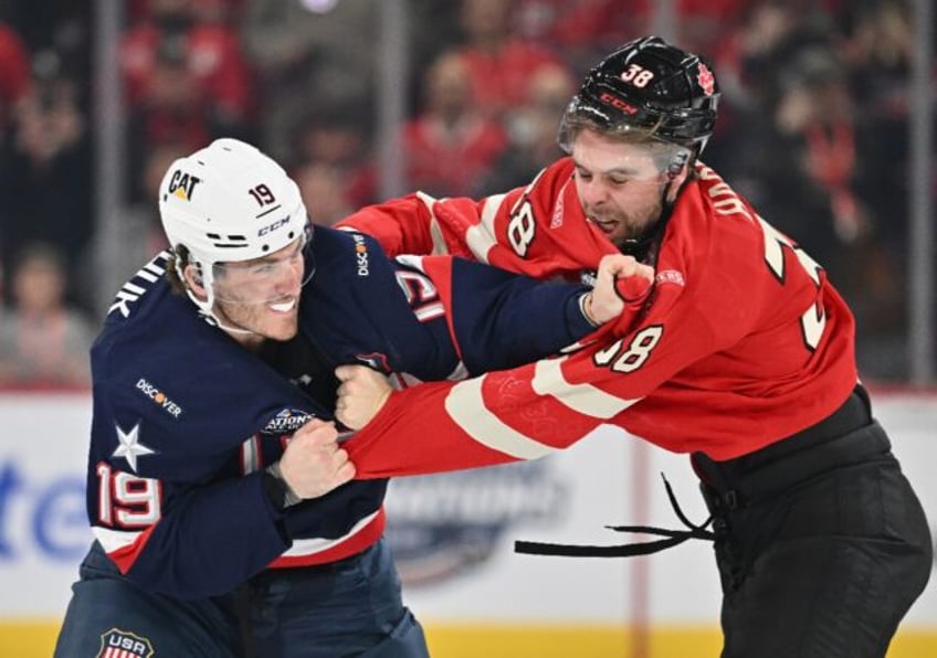 Team USA's Matthew Tkachuk, left, fights Brandon Hagel, right, of Team Canada at the start