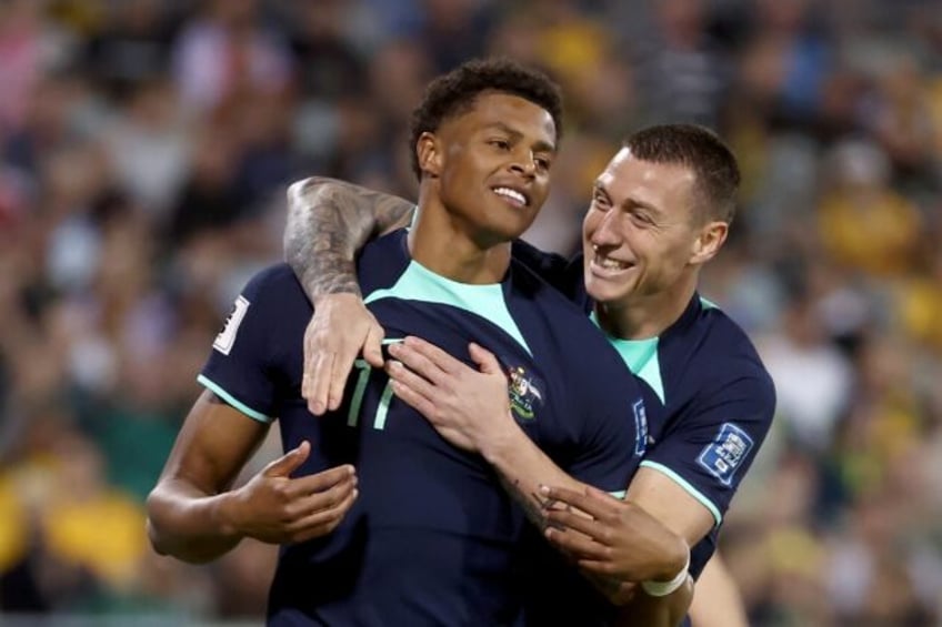 Australia's Kusini Yengi (left) celebrates with teammate Mitchell Duke after scoring agai