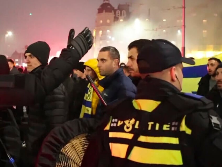 FILE - In this image taken from video, police escort Maccabi Tel Aviv supporters to the me