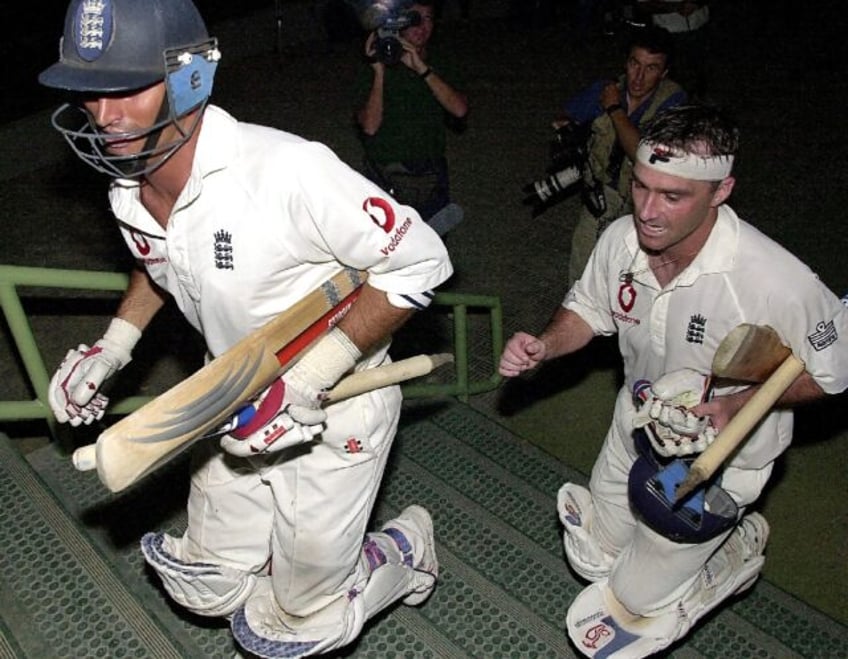 England captain Nasser Hussain (left) and Graham Thorpe rush to the English dressing room